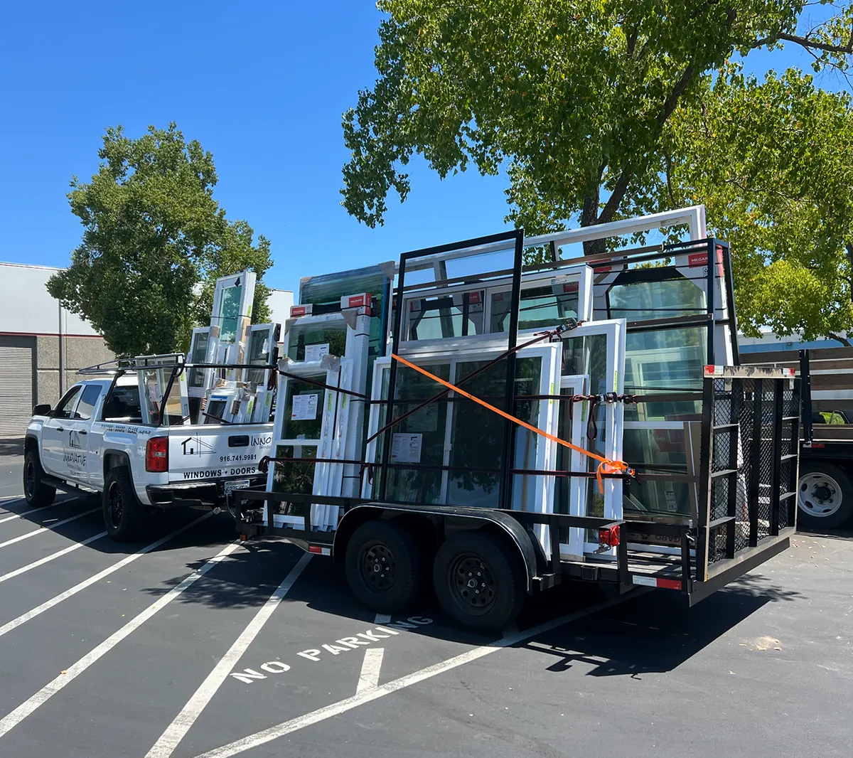 Innovative Windows and Glass truck with a trailer loaded with windows